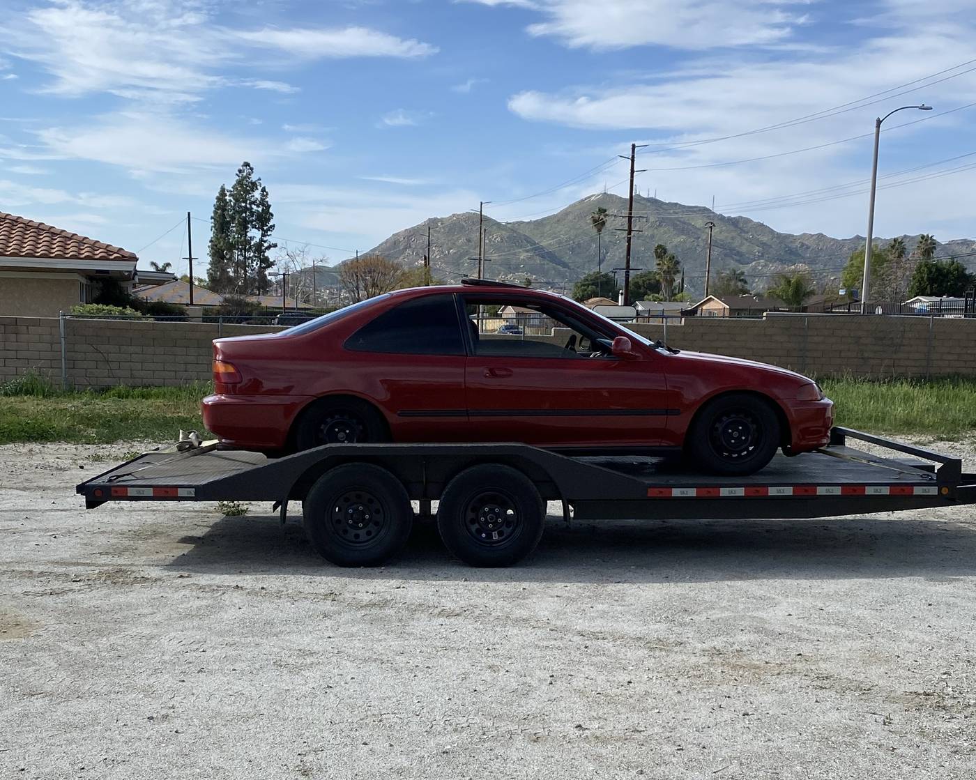 Car loaded on a CDM car hauler trailer